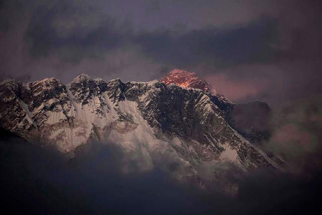In this Oct. 27, 2011 file photo, the last light of the day sets on Mount Everest as it rises behind Mount Nuptse as seen from Tengboche, in the Himalaya's Khumbu region, Nepal.