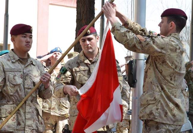 The Canadian Army hauls down the flag in Afghanistan for the last time in Kabul on Wednesday March 12, 2014. 