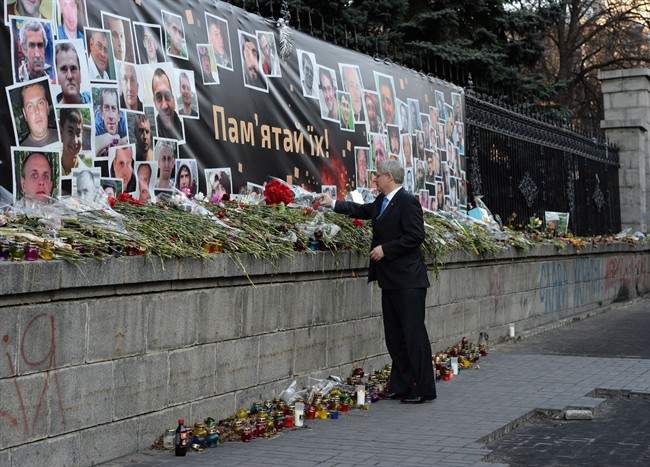Prime Minister Stephen Harper lays a bouquet of flowers in Kiev, Ukraine, on Saturday, March 22, 2014. THE CANADIAN PRESS/Sean Kilpatrick