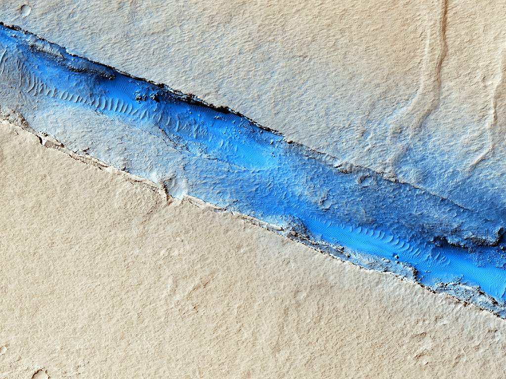 Line in the sand. This image shows a volcanic vent on Mars. Scientists hope to better understand volcano-tectonic processes on the planet by studying images like this one.