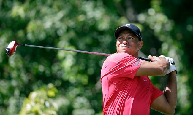 Tiger Woods tees off on the third hole during the final round of the Honda Classic golf tournament on Sunday, March 2, 2014, in Palm Beach Gardens, Fla. 