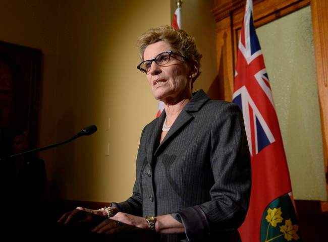 Ontario Premier Kathleen Wynnes talks to media outside her office at Queen's Park in Toronto on Thursday, March 27, 2014.
