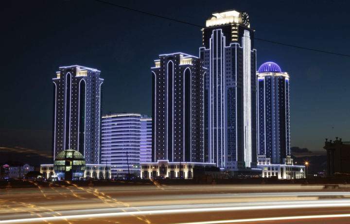 High-rise apartment buildings and a hotel are illuminated in the Chechen regional capital of Grozny, Russia, Wednesday, Dec. 4, 2013.