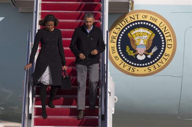 President Barack Obama and first lady Michelle Obama step off Air Force One after arriving at Andrews Air Force Base after spending the weekend in Key Largo, Fla., on Sunday, March 9, 2014, in Andrews Air Force Base, Md.