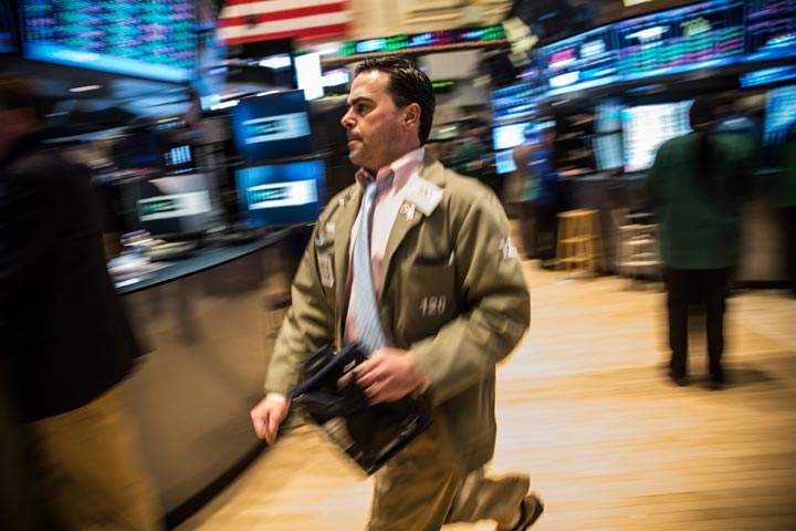 A trader works on the floor of the stock exchange during the afternoon of February 28, 2014 in New York City.  Global stocks tumbled Monday as tension over Russia's military advance into Ukraine and possible sanctions by Western governments intensified.  