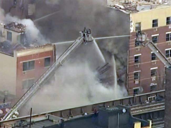 In this image taken from video from WABC, firefighters battle a blaze at the site of a possible explosion and building collapse in the East Harlem neighborhood of New York, Wednesday, March 12, 2014.
