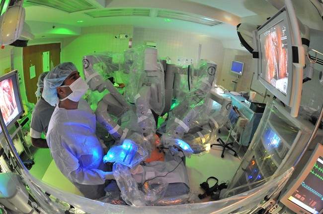 In this Sept. 13, 2011 photo provided by the University of Chicago Medical Center, a doctor watches an internal video of the patient’s body as he assists in prostate cancer surgery at the University of Chicago Medical Center in Chicago.