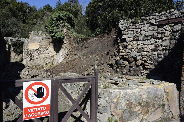 Bricks and rocks are seen on the ground after a section of wall around an ancient shop collapsed in Pompeii as a consequence of a rainstorm, Monday, March 3, 2014. 