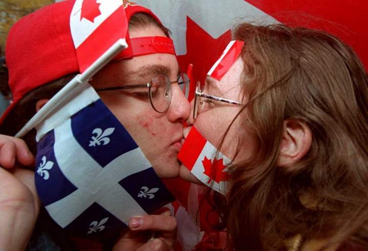 Jonathan Dorozowsky from Quebec kisses his friend Mary Griffen from Canada during a gathering 25 October in downtown Montreal marking the anniversary of a unity rally held last year, following the Quebec referendum.