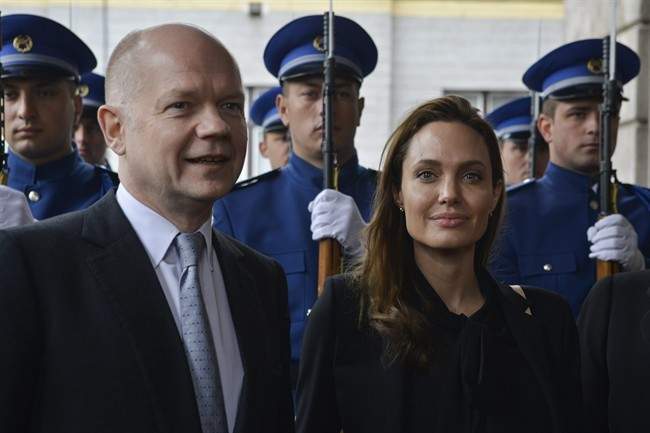UNHCR goodwill ambassador Angelina Jolie and British Foreign Secretary William Hague pose for photographers upon their arrival for a meeting with the Bosnian Presidency in Sarajevo, Bosnia, on Friday March 28, 2014. 