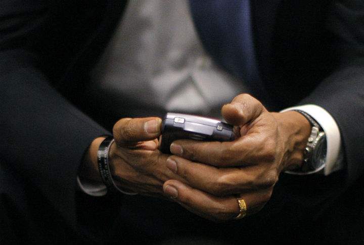 Then-Democratic presidential candidate, Sen. Barack Obama, D-Ill., checks his BlackBerry in St. Louis, in July 2008. (File photo).