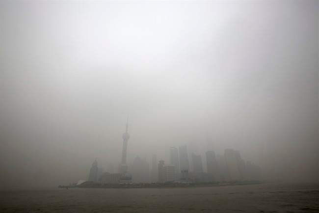 In this Monday, Dec. 9, 2013 file photo, the skyline of the Lujiazui Financial District with the high-rise buildings is covered with heavy smog in Pudong in Shanghai, China.