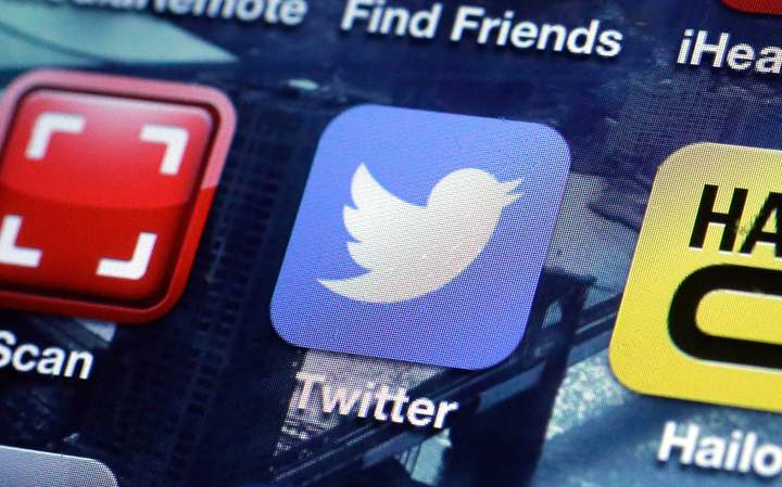 In this Friday, Oct. 18, 2013, file photo, a Twitter app on an iPhone screen is shown, in New York. 