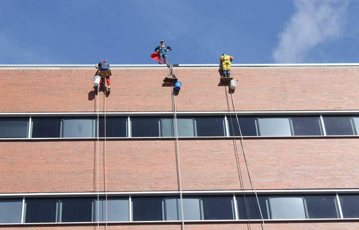 Superman appears on the roof with his friends Spiderman and Wolverine.