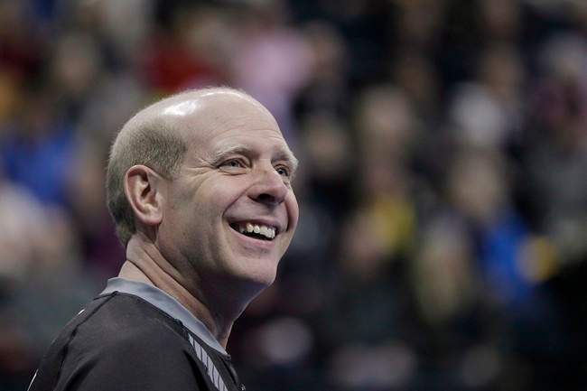 Skip Kevin Martin smiles during the first end of the men's semi-final against John Morris at the 2013 Roar of the Rings Canadian Olympic Curling Trials in Winnipeg, Dec. 7, 2013. Former Olympic champion Martin is retiring from curling.