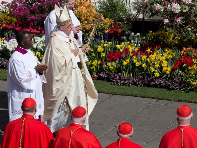 Flowers from the Netherlands decorate St. Peter's Square as Pope Francis arrives to celebrate an Easter Mass in St. Peter's Square at the the Vatican, Sunday, April 20, 2014.