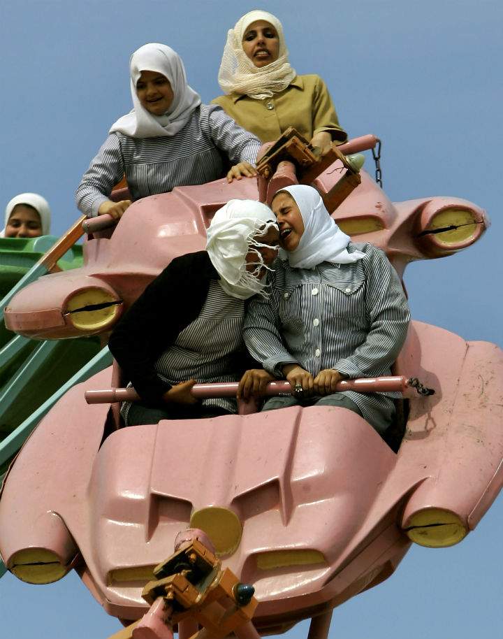 In this Sunday, March 26, 2006 file photo made by Associated Press photographer Anja Niedringhaus, Palestinians enjoy a ride at an amusement park outside Gaza City.