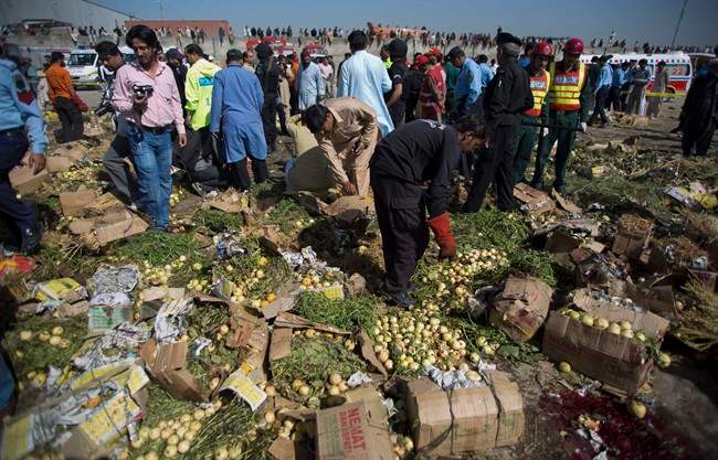 Pakistani investigators look for evidence at the spot of an explosion in Islamabad, Pakistan, Wednesday, April 9, 2014. 