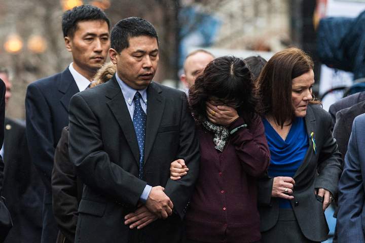 A woman cries during a wreath laying ceremony on the one year anniversary of the 2013 Boston Marathon Bombing, on April 15, 2014 in Boston, Massachusetts.