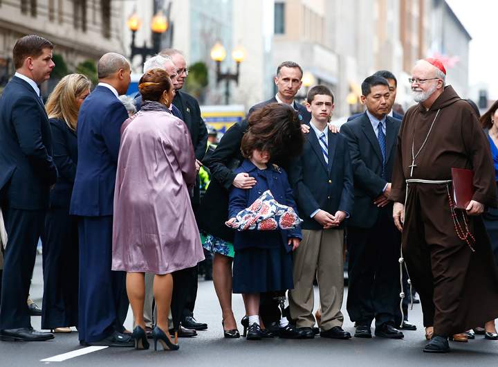 Massachusetts Governor Deval Patrick and Cardinal Sean Patrick O’Malley greet members of the victims families during a wreath-laying ceremony commemorating on April 15, 2014.