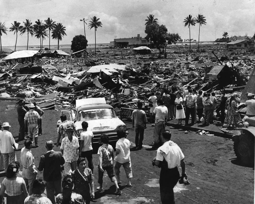 In this 1960 file photo, Residents in Hilo, Hawaii view damage from a tsunami. A powerful earthquake off Chile triggered this tsunami that hit Hawaii in just 15 hours, traveling at 800 km/h.