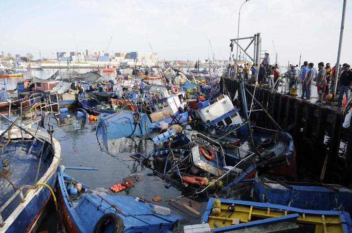 Fishing boats washed ashore by a small tsunami, sit in Caleta Riquelme, adjacent to the port, in the northern town of Iquique, Chile, after magnitude 8.2 earthquake struck the northern coast of Chile, Wednesday, April 2, 2014.