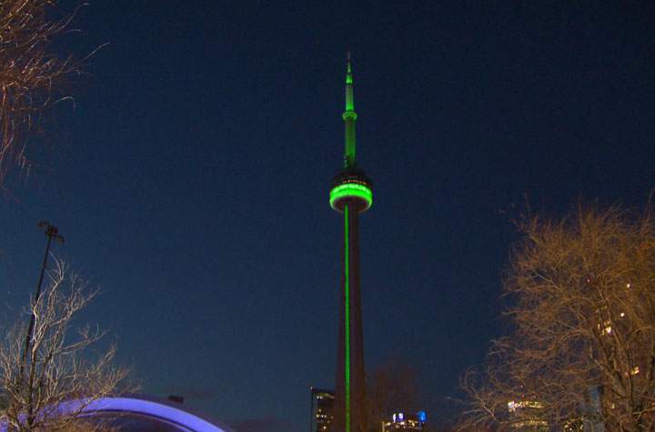 The CN Tower is bathed in green light Friday, April 11, as a tribute to Jim Flaherty.