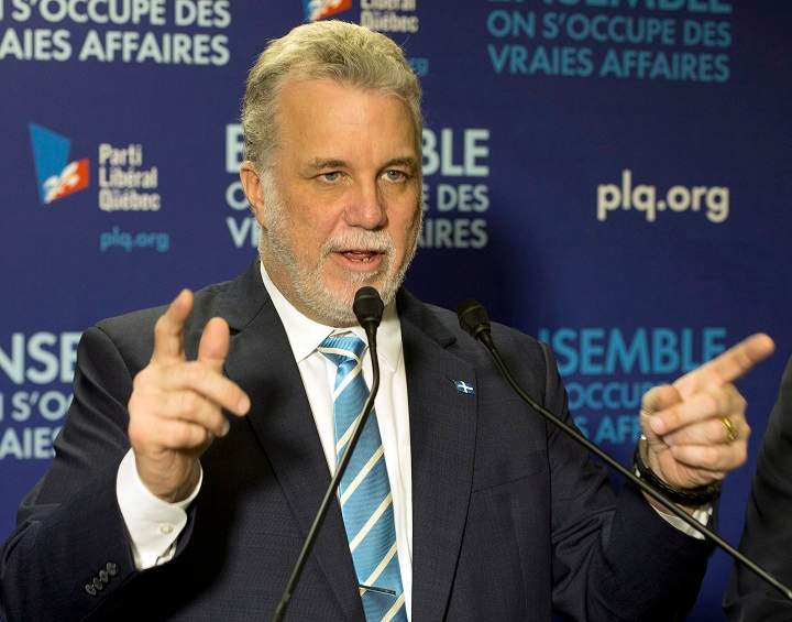 Quebec Liberal leader Philippe Couillard speaks to supporters at the local riding office Thursday, April 3, 2014 while campaigning in Granby, Que. Quebecers will vote in a provincial election April 7, 2014.