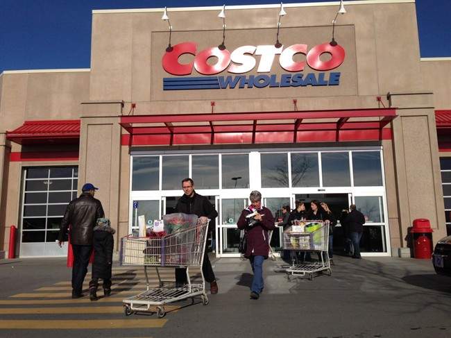 Customers walk out of Costco in Montreal on Saturday, Nov. 17, 2012.