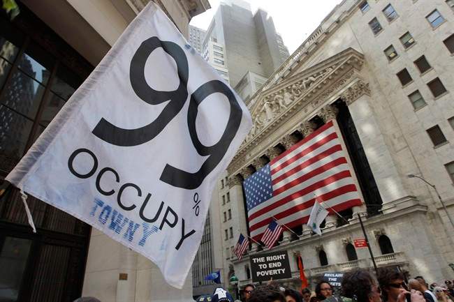 Occupy Wall Street protestors walk past the New York Stock Exchange in 2012.