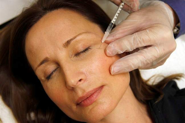 A woman has Botox injected.