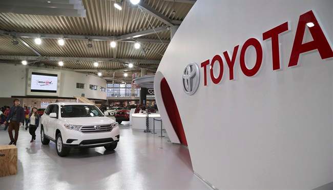 Visitors inspect cars on display at Toyota gallery in Tokyo Feb. 4, 2014.