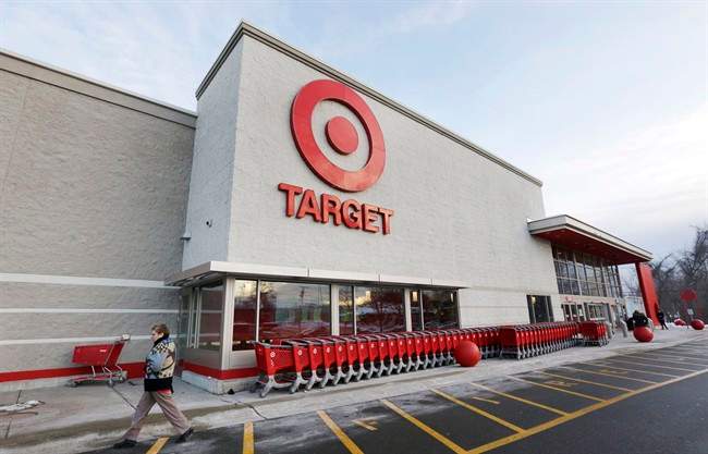 A passer-by walks near an entrance to a Target retail store in Watertown, Mass. on Dec. 19, 2013. 