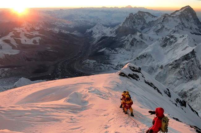 In this May 18, 2013 file photo released by mountain guide Adrian Ballinger of Alpenglow Expeditions, climbers make their way to the summit of Mount Everest, in the Khumbu region of the Nepal Himalayas.