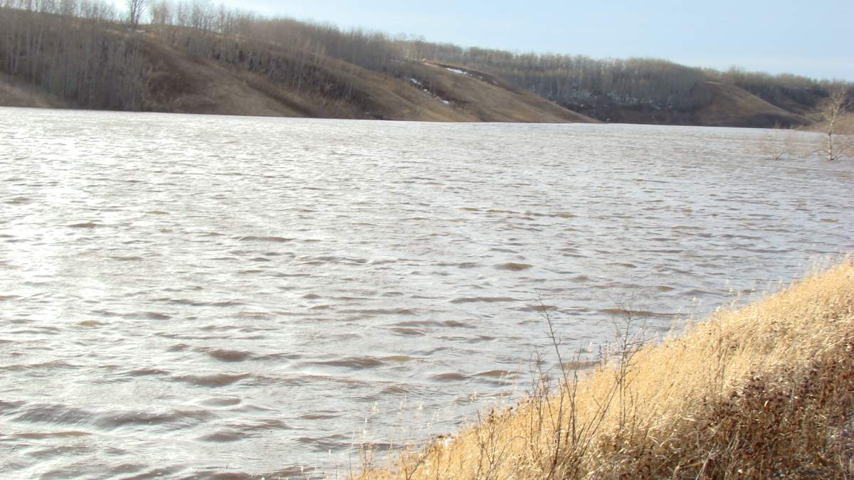 An embankment holding back water on a tributary of Birdtail Creek is failing and a large surge of water is expected to flow quickly down the creek, affecting nearby communities.