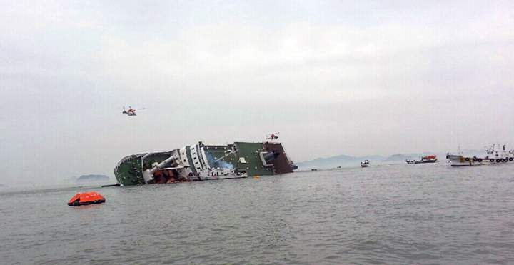 South Korean rescue helicopters fly over, trying to rescue passengers from the ship.