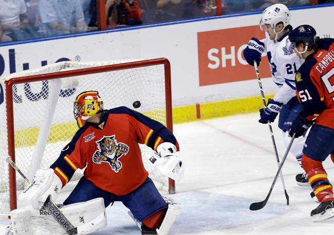 The puck gets past Florida Panthers goalie Roberto Luongo, left, on a goal scored by Toronto Maple Leafs' Tyler Bozak (not shown) in the second period of an NHL hockey game on Thursday, April 10, 2014, in Sunrise, Fla.