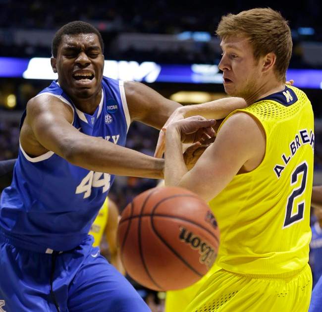 Kentucky's Dakari Johnson (44) and Michigan's Spike Albrecht (2) go after a loose ball during the first half of an NCAA Midwest Regional final college basketball tournament game Sunday, March 30, 2014, in Indianapolis.