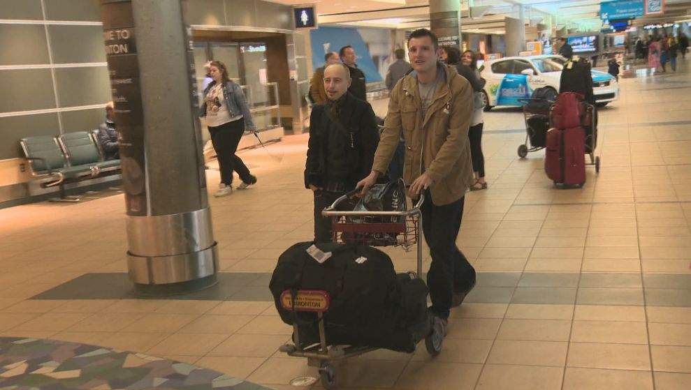 James Birkbeck (accompanied by his cousin on the left) getting ready to head back to the U.K. Wednesday afternoon.