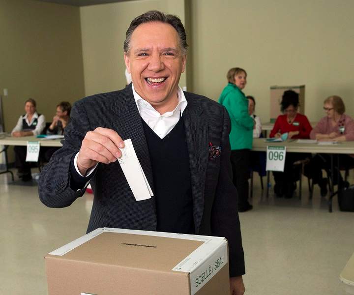 Coalition Avenir du Quebec leader Francois Legault gets set to cast his ballot Monday, April 7, 2014 in L'Assomption, Que.