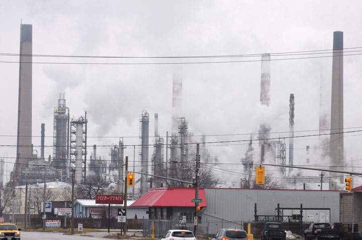 The Imperial Oil refinery at Sarnia, Ontario with pollution from smokestacks and city streets.