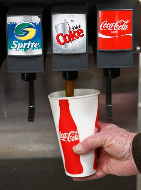 FILE - In this March 3, 2010 file photo, a Costco customer pours a Diet Coke drink at Costco in Mountain View, Calif. The fixation on calorie counts that defined dieting for so long is giving way to other considerations, like the promise of more fiber or natural ingredients. The shift is chipping away at the popularity of products like Diet Coke, Lean Cuisine, Special K and Yoplait Light, which became dieting staples primarily by virtue of being calorie-stripped alternatives to people’s favorite foods. (AP Photo/Paul Sakuma, file)