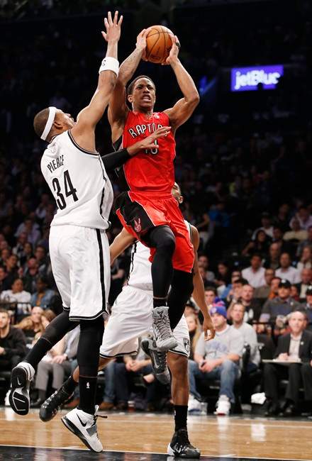 Brooklyn Nets forward Paul Pierce (34) defends against Toronto Raptors guard DeMar DeRozan (10) as DeRozan goes up for a layup in the first half of Game 4 of an NBA basketball first-round playoff series at the Barclays Center, Sunday, April 27, 2014, in New York.