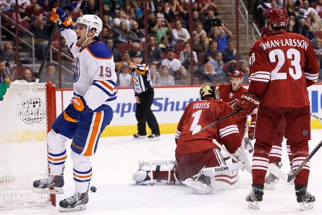Edmonton Oilers' Justin Schultz (19) celebrates his goal against Phoenix Coyotes' Thomas Greiss (1), of Germany, as Coyotes' Oliver Ekman-Larsson (23), of Sweden, and Lauri Korpikoski, rear, of Finland, watch during the first period of an NHL hockey game, Friday, April 4, 2014, in Glendale, Ariz.