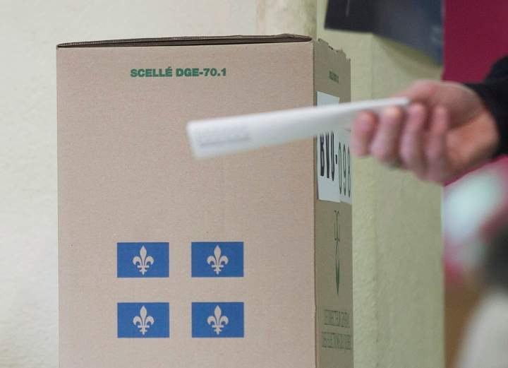 A man casts his ballot at a polling station in Montreal, Monday, April 7, 2014.