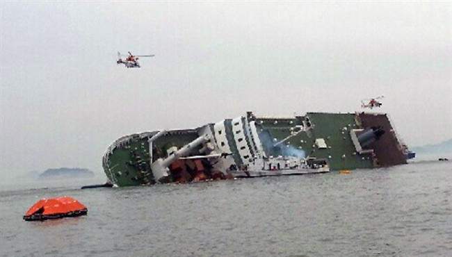 South Korean rescue helicopters fly over a South Korean passenger ship, trying to rescue passengers from the ship in water off the southern coast in South Korea, Wednesday, April 16, 2014.