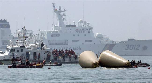 Relatives, center, of passengers aboard the sunken Sewol ferry visit the site where the ship sank to observe the search operation in the water off the southern coast near Jindo, South Korea, Thursday, April 24, 2014. 