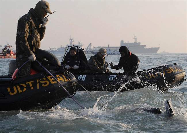 Divers look for people believed to have been trapped in the sunken ferry off the coast of South Korea.