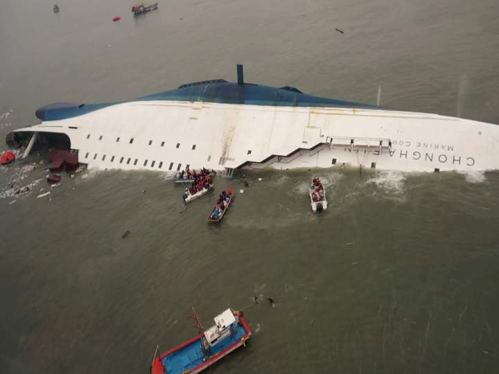 In this photo released by South Korea Coast Guard via Yonhap News Agency, South Korean rescue team boats and fishing boats try to rescue passengers.