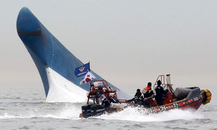 South Korean coast guard officers try to rescue passengers.